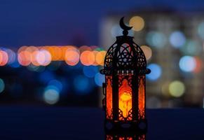 Selective focus of lantern with apartment building background for the Muslim feast of the holy month of Ramadan Kareem. photo