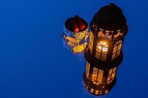 Lantern with dates fruit reflection from mirror background for the Muslim feast of the holy month of Ramadan Kareem. photo