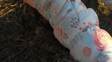 close up of child hand cutting a green grass on the meadow  at warm summer day video