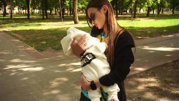 Stylish young mom with a little baby in her arms video