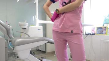 charming dentist in pink uniform in clinic video