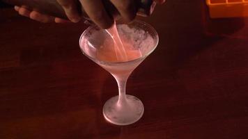 close up of Man pours drink into cocktail glass video