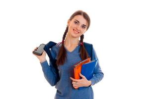 portrait of young attractive student girl with backpack and notebooks isolated on white background photo