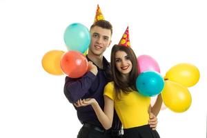 funny guy and girl smiling and holding a lot of air of colored balls photo