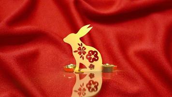 The gold rabbit and vintage Chinese money on red background  3d rendering photo