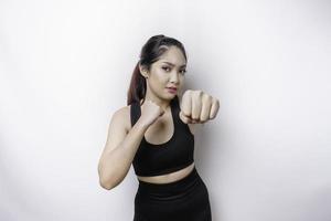 Beautiful sporty Asian woman fighter trains boxing in studio on white background. Martial arts concept photo