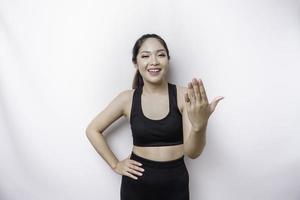 Young Asian beautiful sporty woman over isolated white background inviting to join with hand. Happy that you came photo