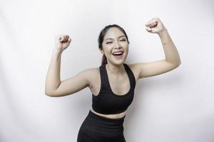 A young sporty Asian woman with a happy successful expression wearing sportswear isolated by white background photo
