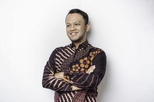 Shot of a Asian young confident man posing with crossed arm against a white background. photo