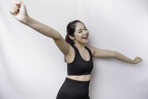 A young sporty Asian woman with a happy successful expression wearing sportswear isolated by white background photo