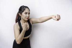 Beautiful sporty Asian woman fighter trains boxing in studio on white background. Martial arts concept photo