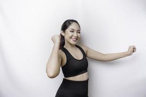 A young sporty Asian woman with a happy successful expression wearing sportswear isolated by white background photo