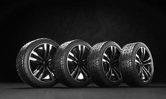 Four car wheels on the asphalt on a black background. 3D rendering illustration. photo