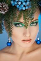 Vertical photo of sexy young woman with wreath-tree on head at christmas time