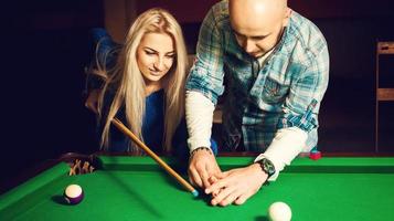 Glamour couple plays billiard for the first time photo