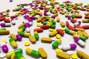 A lot of colorful medication and pills from above. 3D rendering illustration photo