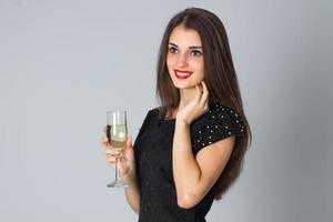 girl in black dress posing in studio photo