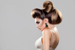 Profile portrait of young sexy woman with creative hairstyle and nice makeup photo