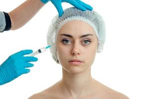 woman makes prick in face plastic surgeon photo