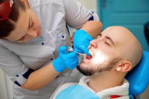 foto de primer plano del paciente en el examen de los dientes en el dentista