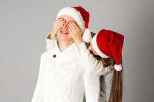 couple in love celebrates christmas in santa hat photo