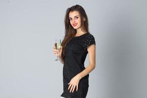 girl in black dress posing in studio photo