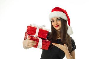 Happy girl in santa hat with red gift photo