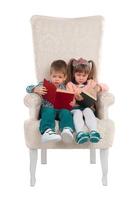 Children sit in a chair with books photo