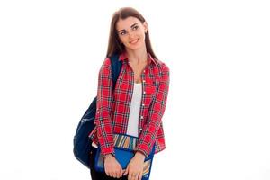 portrait of young cheerful student girl with backpack and folders for notebooks isolated on white background photo