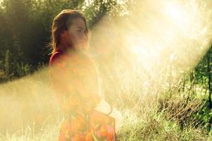 Pregnant girl in dress in nature photo