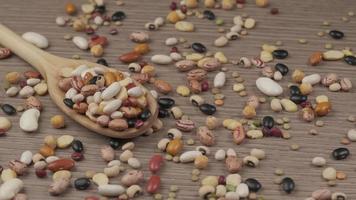 Dry mixed beans, chickpeas, lentils vegan vegetarian protein source, Mediterranean healthy diet rotating on wooden spoon, organic agriculture video