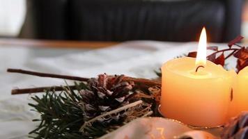 Four burning candles on Christmas wreath shining bright with romantic mood at Holy eve and Christmas holidays infront of a festive decorated Christmas tree as traditional christian symbol for advent video