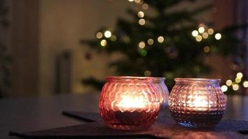 Burning Christmas candles of a festive Christmas wreath with four candles burning in advent time for cozy atmosphere in Christmas season on holy eve or xmas preparation with tranquil mood and coziness video