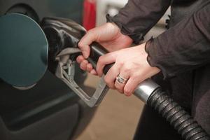 mujer bombeando gasolina foto