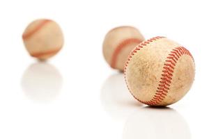 tres pelotas de béisbol aisladas en blanco reflectante foto