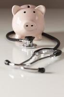 Piggy Bank and Stethoscope with Selective Focus photo