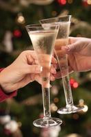 Man and Woman Toasting Champagne in Front of Lights photo