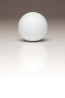 sola pelota de golf blanca sobre fondo degradado foto