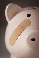 Piggy Bank with Bandage on Face photo