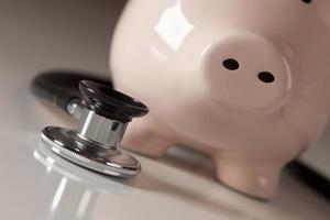 Piggy Bank and Stethoscope with Selective Focus photo