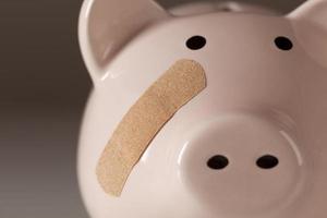 Piggy Bank with Bandage on Face photo