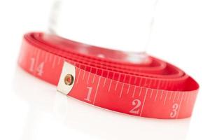 Red Measuring Tape and Water Bottle on White photo