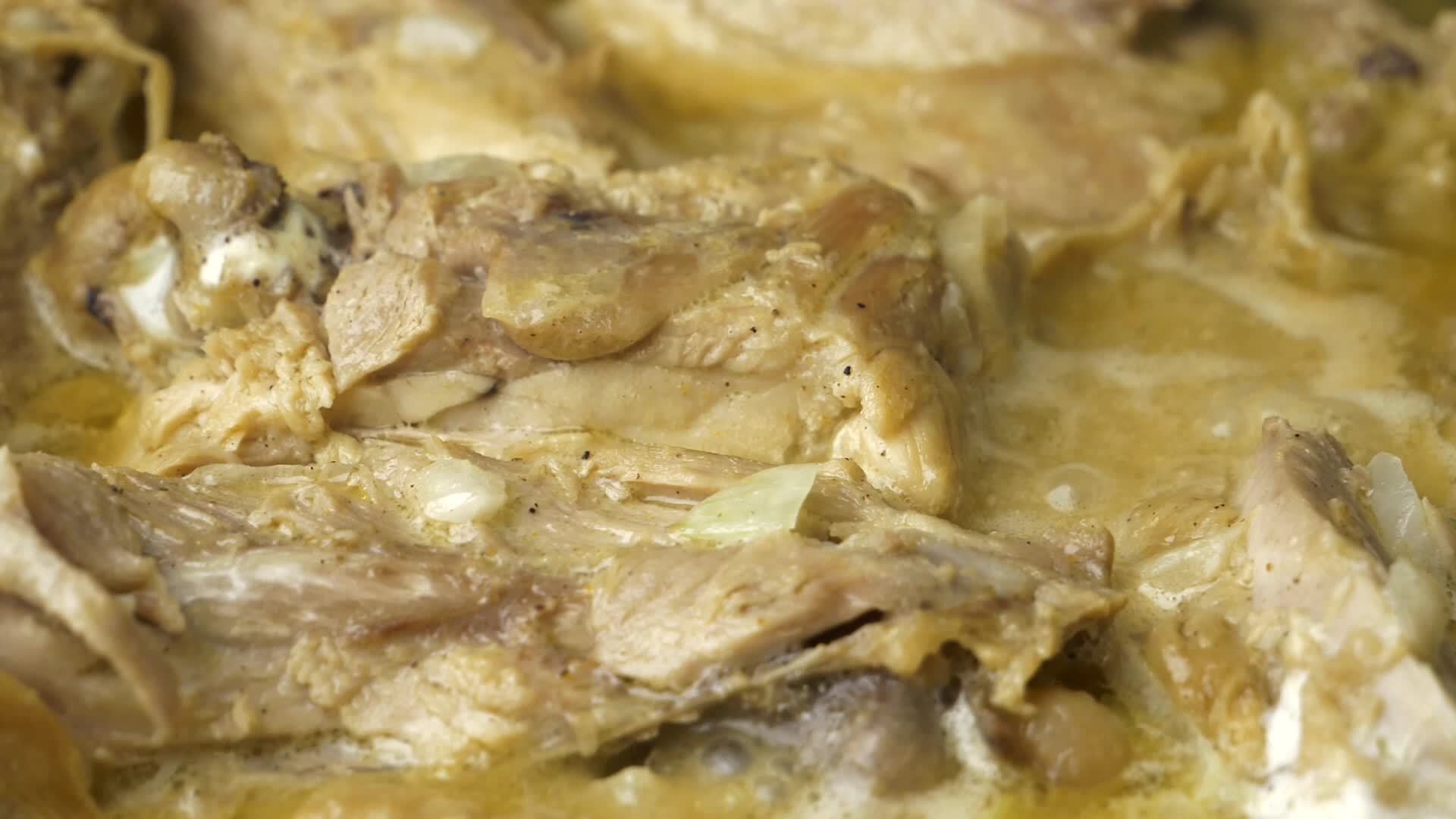 chicken meat in boiling sauce closeup 16355418 Stock Video at Vecteezy