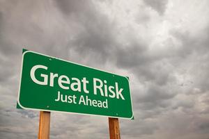 Great Risk Green Road Sign Over Storm Clouds photo