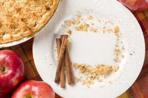 Pie, Apples, Cinnamon Sticks and Copy Spaced Crumbs on Plate photo