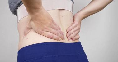 woman with back pain, hernia in the lower back video