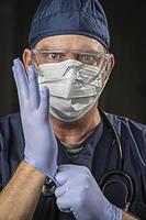 Determined Looking Doctor or Nurse with Protective Wear and Stethoscope photo