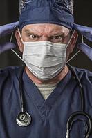 Determined Looking Doctor or Nurse with Protective Wear and Stethoscope photo