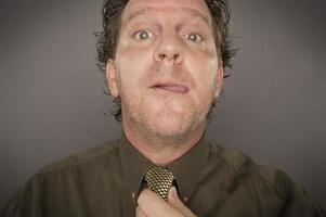 Man Concentrating Fixing Tie photo