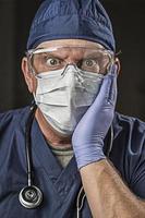 Stunned Doctor or Nurse with Protective Wear and Stethoscope photo